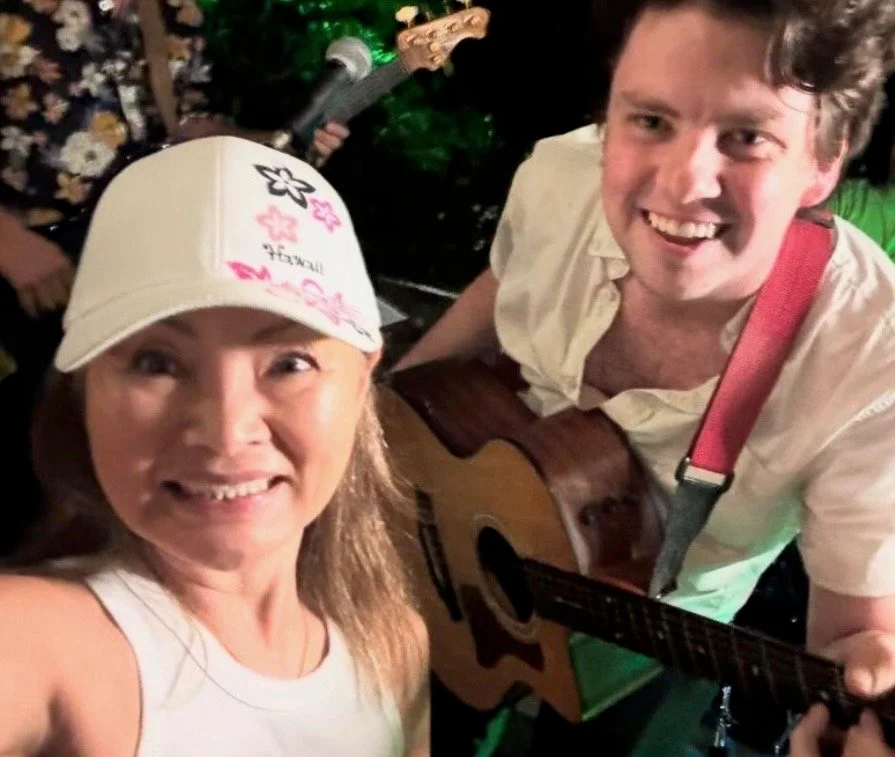 Matt Tuley smiling with a guest after a performance