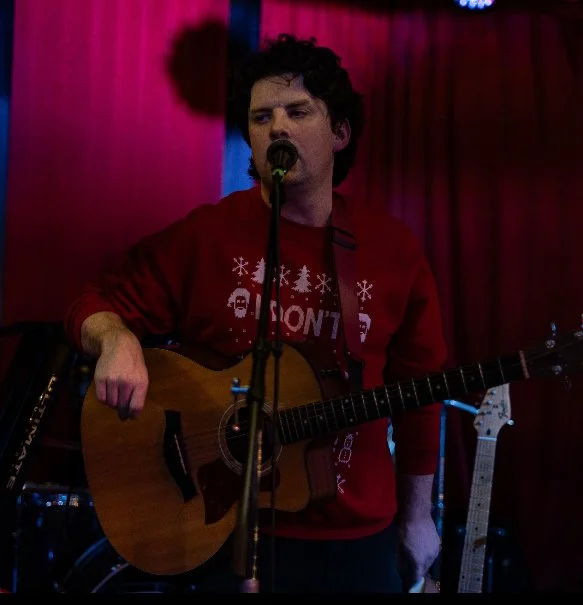 Matt Tuley performing at a holiday party